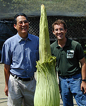 two men standing next to bud